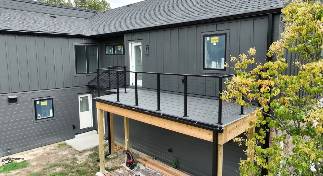Elevated deck on gray house showcasing professional installation